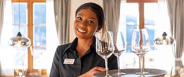 Eine Frau serviert Gläser